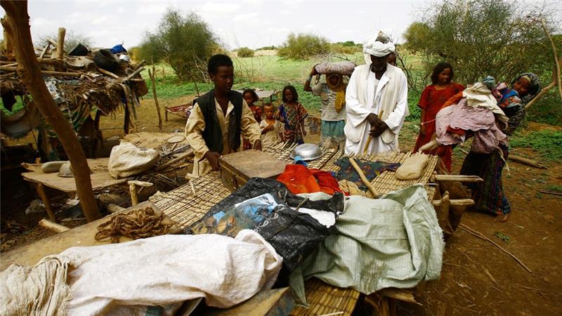 Family Flees Flooded Village in Sudan 